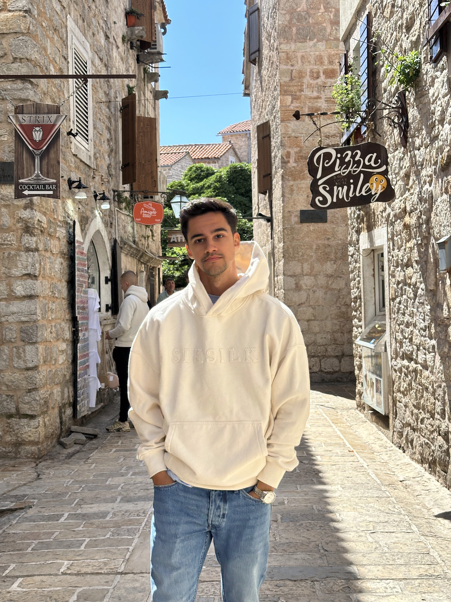 Rodrigo standing in a stone-paved old-town street